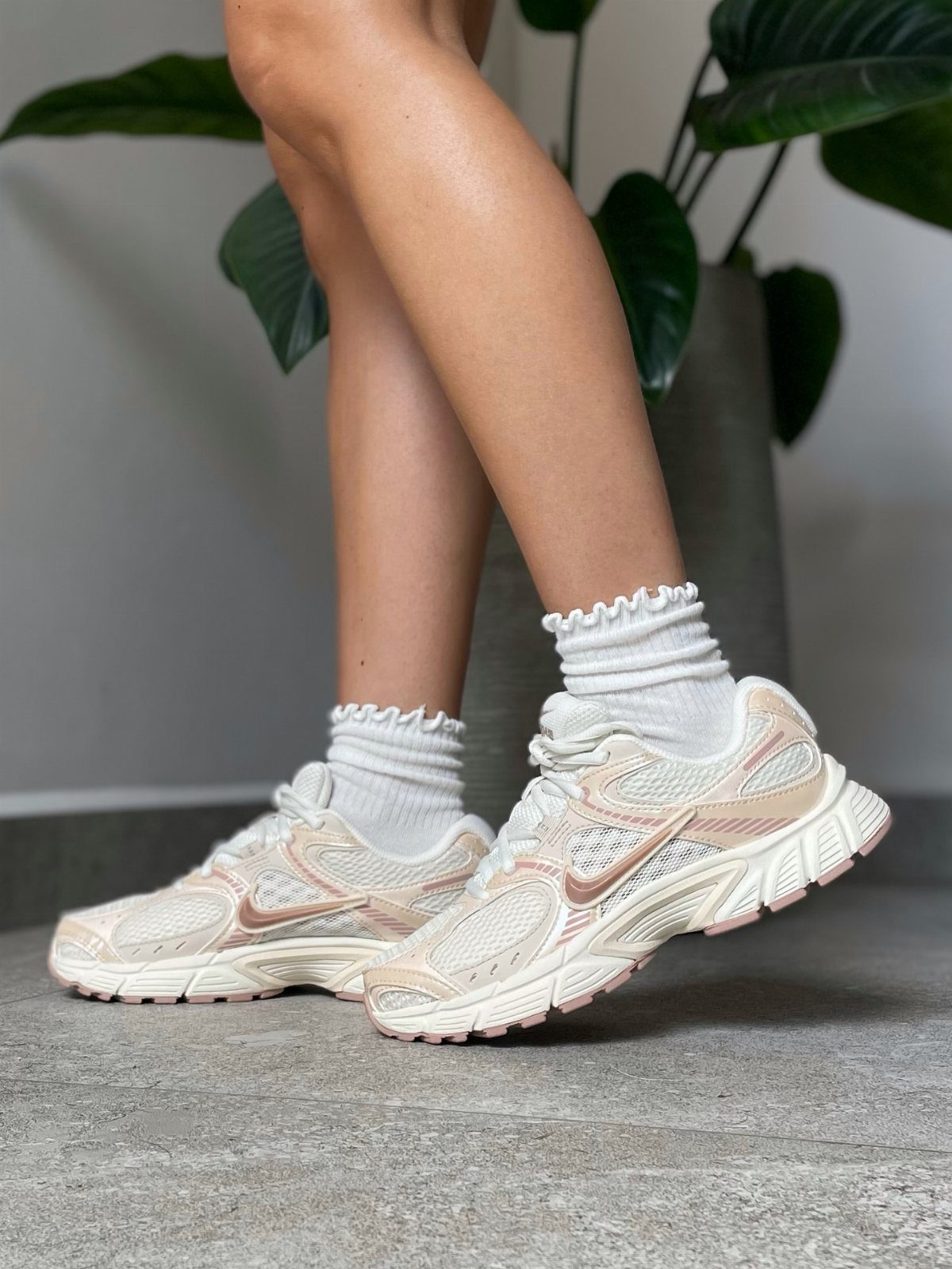 Pink and White Designer Sneakers: 5 Pairs for Women 1 Pink and white Nike V5 Rnr sneakers worn with white ruffled socks.