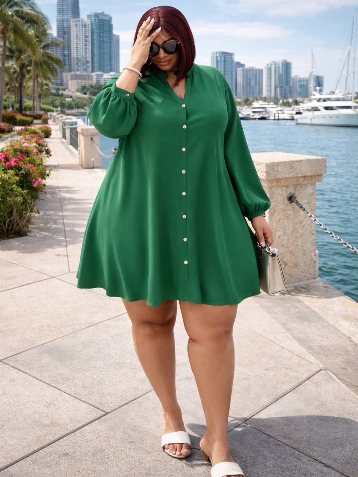 13 Plus Size Brunch Outfit Ideas for Every Style 8 Plus-size woman in a green button-down shirt dress and white sandals by the waterfront.