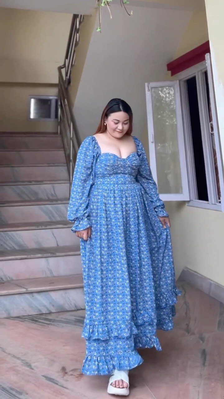 13 Plus Size Brunch Outfit Ideas for Every Style 6 Plus-size woman in a blue floral tiered maxi dress and white flat sandals.