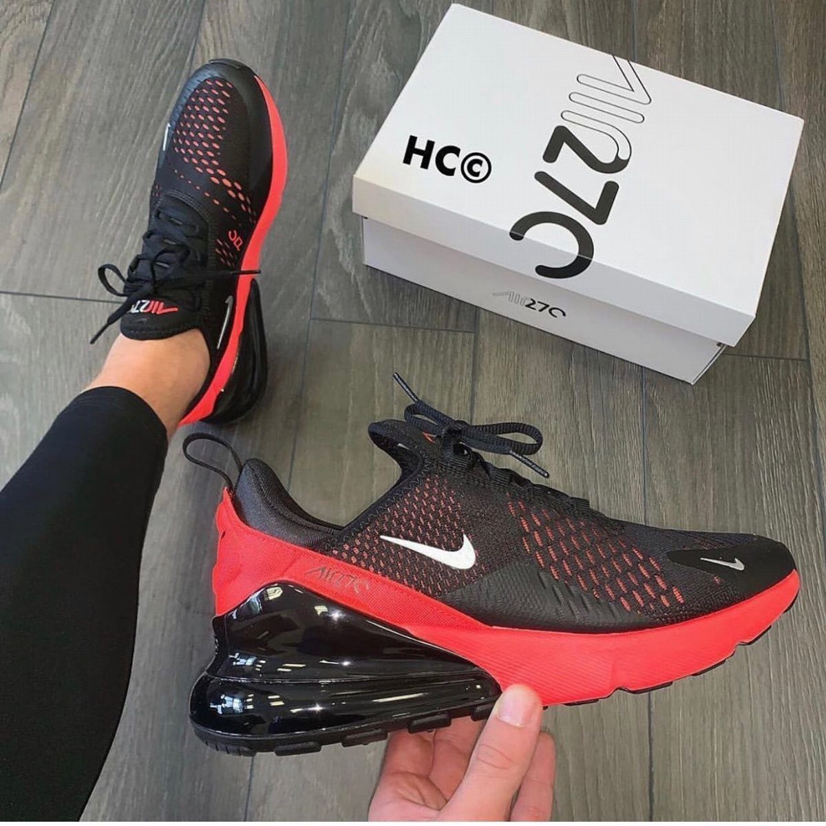 Red and black Nike Air Max 270 sneakers with a white shoe box.