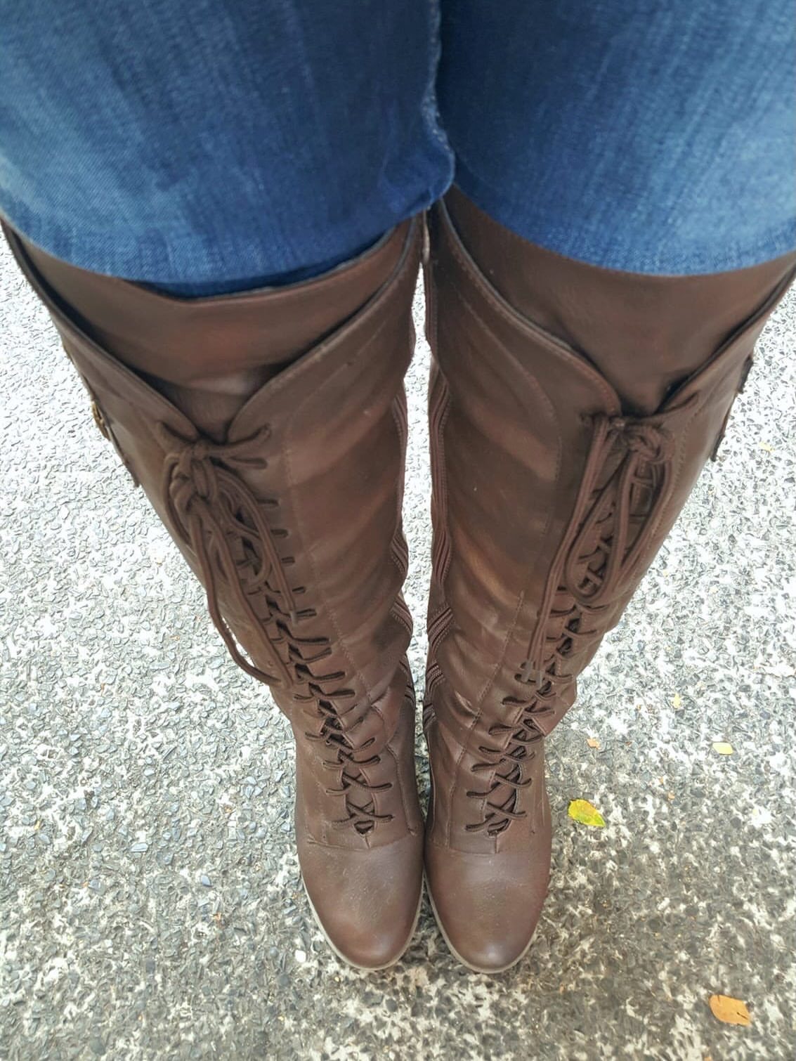 Scrunch Knee High Boots: 7 Ideas for Every Outfit 3 Brown leather scrunch knee high boots with laces worn with blue jeans.