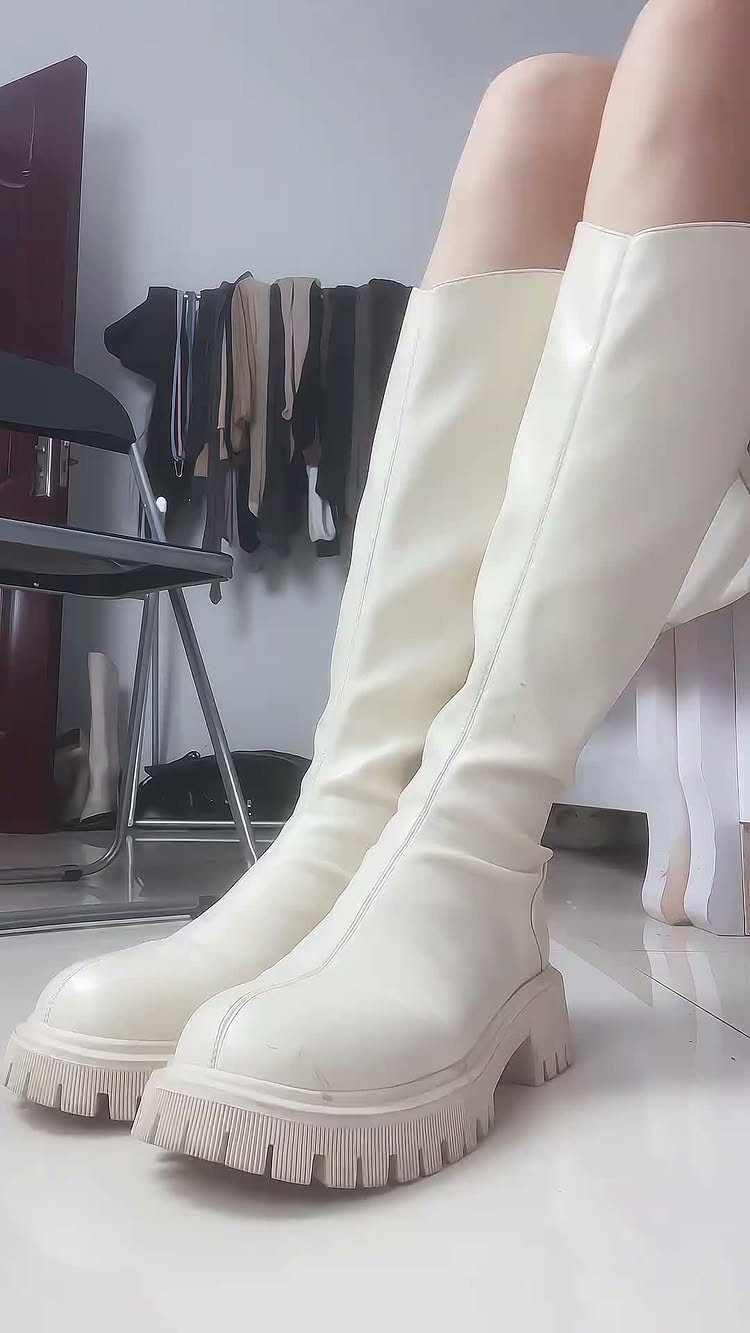 Scrunch Knee High Boots: 7 Ideas for Every Outfit 5 White knee-high boots with chunky soles and scrunching worn by a person.