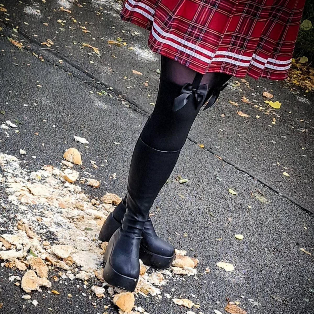 Scrunch Knee High Boots: 7 Ideas for Every Outfit 2 Black platform knee high boots paired with a red plaid skirt and black stockings.