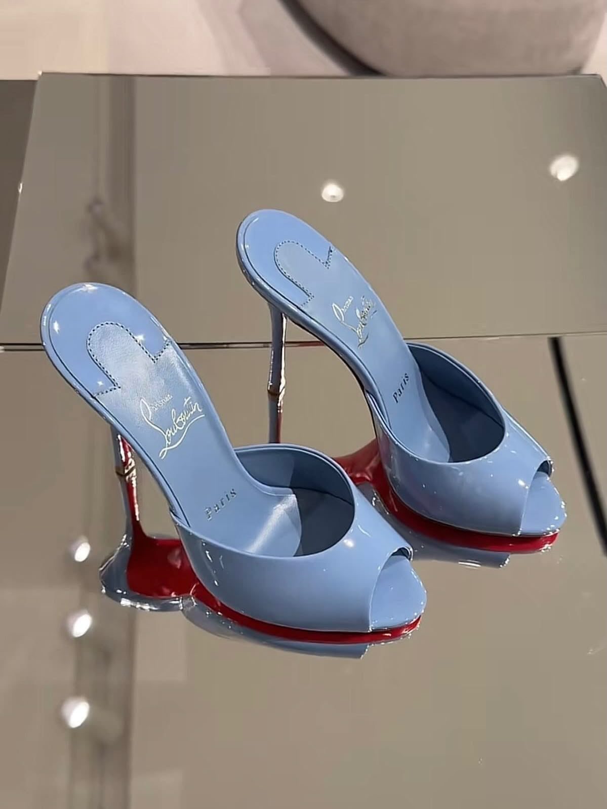 Tiffany Blue High Heels: 5 Ideas, From Satin to Platform 4 Light blue open-toe high heel sandals with red soles on a mirrored surface.