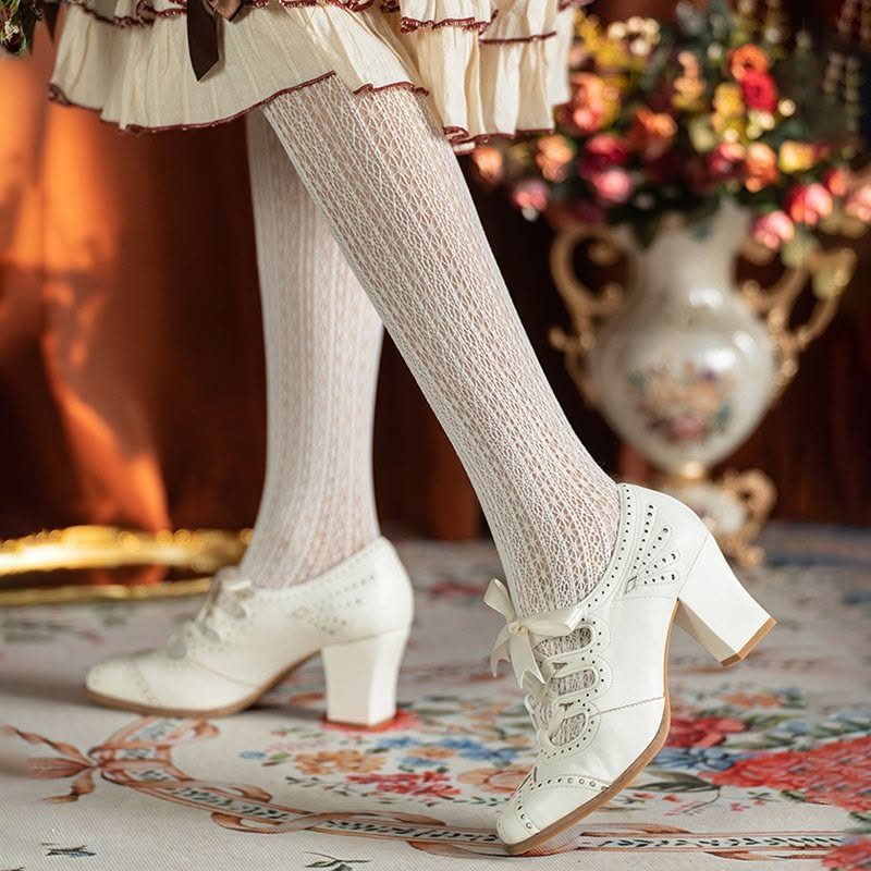 Vintage Shoes and Heels: 8 Styles From Mary Janes to Boots 5 White lace-up block heel pumps with cutout details worn with patterned white tights.