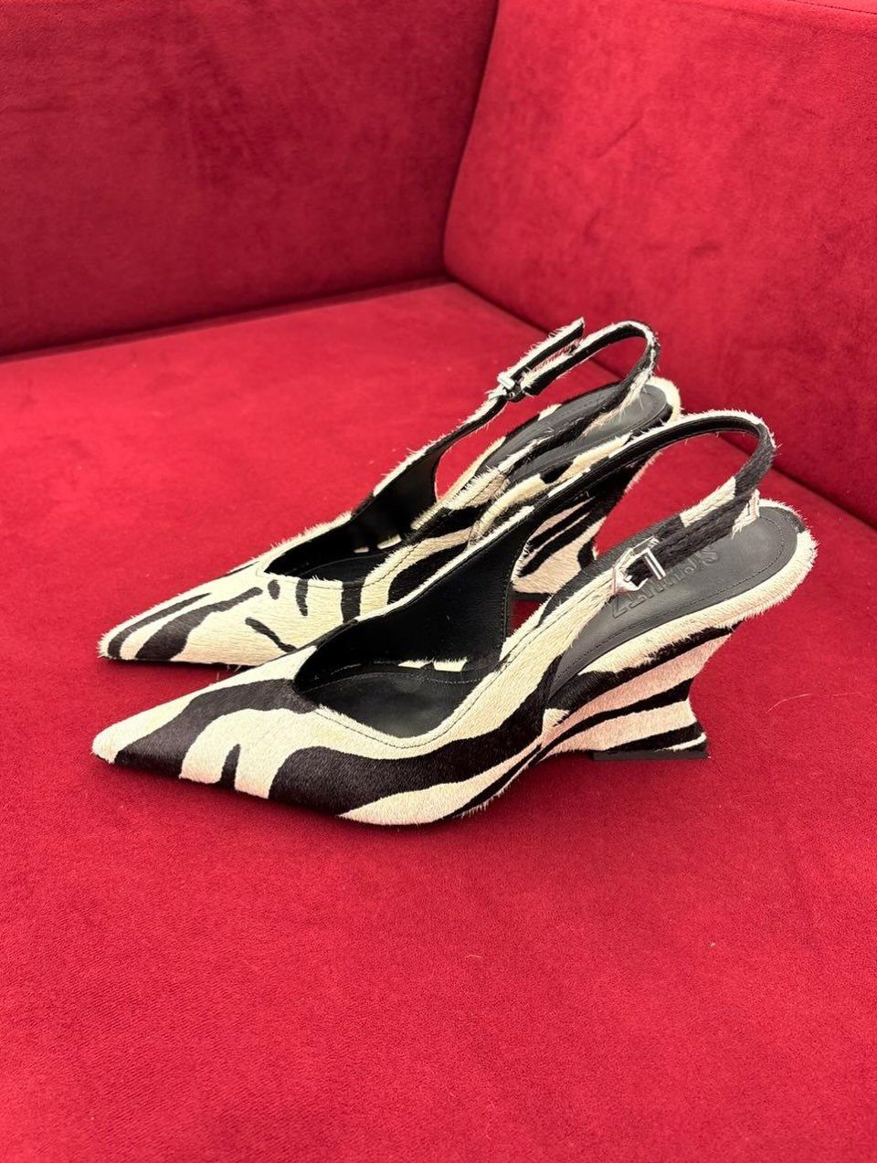 Zebra Kitten Heels: 7 Styles from Slingbacks to Mules 4 Zebra print kitten heels with slingback straps on a red velvet background.